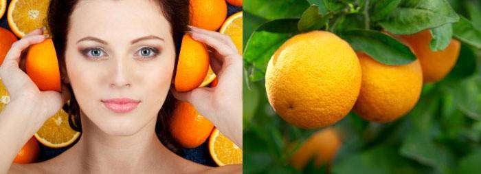 Женщина держит апельсины