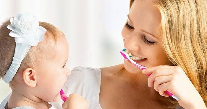 Мама и ребенок чистят зубы, чтобы избежать болячек губ