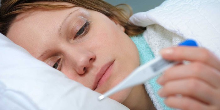 Женщина смотрит на термометр