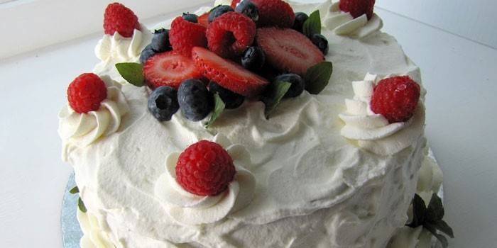 Торт украшенный белковым кремом и ягодами