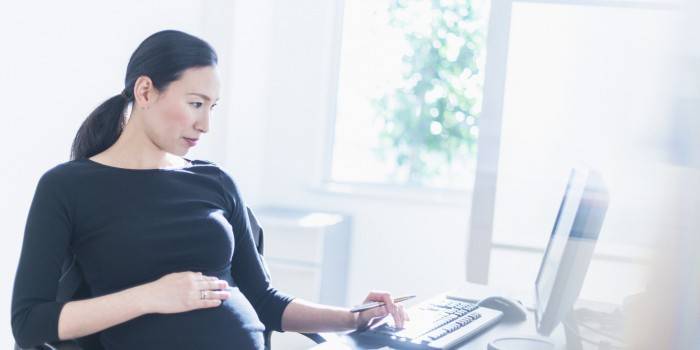 Беременная женщина за компьютером